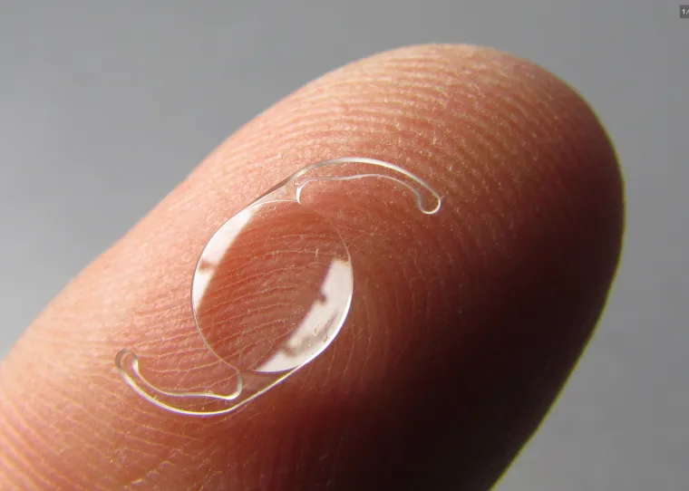 Intraocular lens on a fingertip for scale